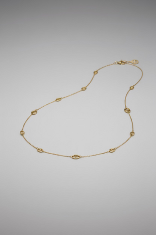A delicate gold chain necklace with small oval links