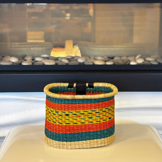 Colorful woven basket on a white surface with a blurred background