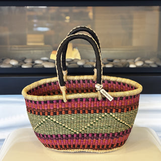 Woven basket with striped pattern on a white surface
