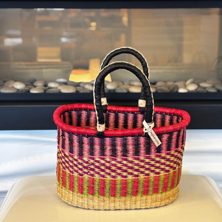 Woven basket with striped pattern on a white surface