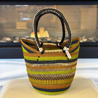 Woven basket with striped pattern on a white surface