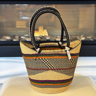 Woven handbag with striped pattern on a white surface