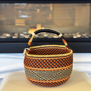Woven basket with a checkered pattern on a white surface