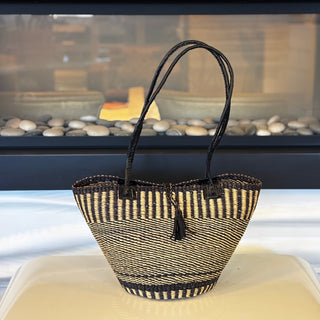 Woven basket with striped pattern on a white surface